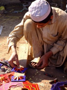 Pakistan man painting logos for a bus